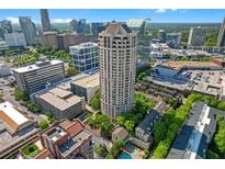 Stunning aerial view of a high-rise building in a vibrant cityscape with many surrounding buildings and lush greenery at 3475 Oak Valley Rd # 660, Atlanta, GA 30326
