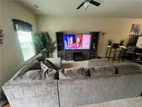 Spacious living room featuring a large sectional sofa and entertainment center at 4039 Braxton Sw Pl, Atlanta, GA 30331