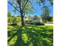 Charming home with beautiful landscaping, mature trees, and a welcoming front porch at 4715 Hill Rd, Powder Springs, GA 30127