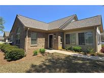 Charming brick home featuring a well-manicured lawn and an inviting front entrance at 102 Silver Summit Se Dr, Conyers, GA 30094