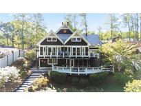 Stunning two-story home with a spacious deck, perfect for outdoor entertaining in a wooded setting at 6255 Lakeview Dr, Buford, GA 30518