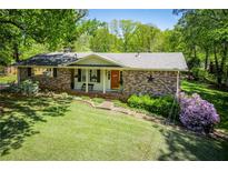 Charming brick home featuring a well-manicured lawn and colorful landscaping at 3224 Laura Way, Winston, GA 30187
