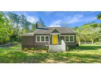 Charming single-Gathering home with a well-maintained lawn and a bright yellow front door at 3460 Old Fairburn Rd, South Fulton, GA 30349