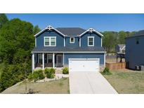 Beautiful two-story home featuring a well-manicured lawn and a two-car garage at 3690 Summerpoint Xing, Cumming, GA 30028