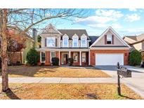 Charming two-story home with a well-maintained front yard, inviting curb appeal, and attached garage at 1481 Wild Rye Ln, Grayson, GA 30017