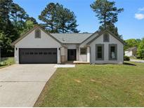 Charming single story home featuring a 2 car garage, manicured lawn, and welcoming front facade at 7171 Hazelwood Dr, Jonesboro, GA 30236