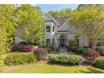 Charming traditional home featuring a manicured lawn and mature landscaping at 350 Covered Bridge Sw Pl, Smyrna, GA 30082