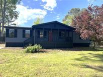 Charming home featuring a quaint front porch and freshly painted exterior, nestled in a sunny lot at 106 Evergreen Trl, Cartersville, GA 30121