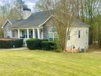 Charming single-Gathering home with stone accents, covered porch, and lush lawn at 25 Derby Dr, Hiram, GA 30141