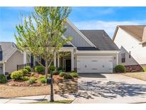 Charming two-story home featuring a two-car garage and beautifully landscaped front yard at 408 Windy Ridge Way, Canton, GA 30114