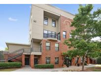 Beautiful exterior view of a brick building featuring lovely balconies and mature landscaping at 898 Oak St # 2003, Atlanta, GA 30310