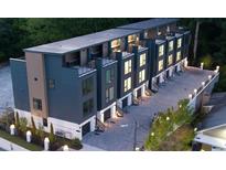 Stunning modern townhome exterior featuring a rooftop terrace and private garage at 1570 Flat Shoals Se Rd # 7, Atlanta, GA 30316