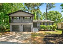 Charming two-story home boasts a painted brick facade, inviting entryway, and a well-manicured front yard at 2302 Aurie Dr, Decatur, GA 30034