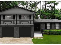 Charming two-story home featuring an attached garage and inviting front yard, all painted in neutral gray tones at 2302 Aurie Dr, Decatur, GA 30034