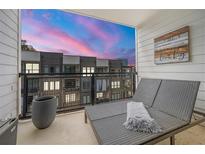 Relaxing balcony featuring a daybed, a stylish planter and views of colorful sunset at 383 Pratt Se Dr # 506, Atlanta, GA 30315