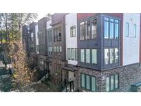 Modern townhome showcasing a brick facade, large windows, and a contemporary design at 383 Pratt Se Dr # 506, Atlanta, GA 30315