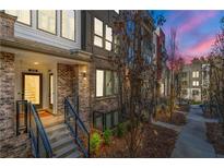 Stylish townhome featuring a brick facade, metal railings, and a well-maintained walkway leading to the entrance at 383 Pratt Se Dr # 506, Atlanta, GA 30315