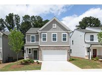 Charming two-story home with brick accents, a two-car garage, and a well-manicured lawn at 612 Belshire Dr, Acworth, GA 30102