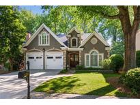 Charming home with a well-manicured lawn, two car garage and mature trees in a beautiful neighborhood at 3803 Mill Creek Ct, Atlanta, GA 30341