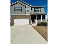 Charming two-story home featuring a brick and gray facade, complemented by a well-maintained front lawn at 4685 Trefoil Path, Cumming, GA 30040