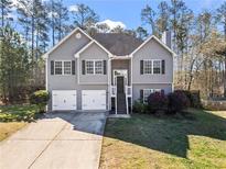 Charming two-story home featuring gray siding, a two-car garage, and a well-maintained front yard at 41 Jessica Ln, Dallas, GA 30157