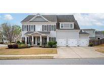Traditional two-story home with a three-car garage and beautiful gray siding at 524 Tackett Farms Rd, Smyrna, GA 30082