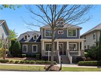 Charming two-story home featuring a welcoming front porch and beautiful landscaping at 9988 Devonshire St, Douglasville, GA 30135