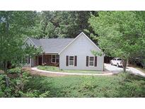 Charming home featuring a combination of brick and light siding, complemented by dark shutters at 7675 Lanier View Rdg, Cumming, GA 30041