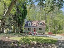 Charming two-story home with a landscaped yard and welcoming front porch and a fire pit at 1004 Westminister Ct, Woodstock, GA 30188