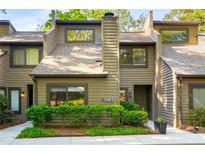 Inviting townhouse with a landscaped front yard, featuring a charming facade and natural surroundings in a desirable neighborhood at 2002 Cedar Chase Ne Ln, Atlanta, GA 30324