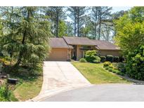Stunning single Gathering home featuring a beautiful driveway, attached garage, and gorgeous landscaping at 4030 Muirfield Ln, Marietta, GA 30068