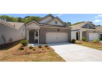 Charming brick home featuring an attached garage and a well-manicured front yard at 2617 Cacao Sq, Acworth, GA 30101