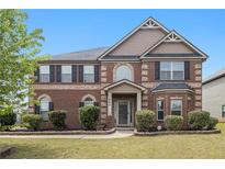 Charming two-story brick home featuring manicured landscaping and a welcoming front porch, enhancing curb appeal at 640 Parkside Place Dr, Mcdonough, GA 30253