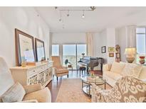 Inviting and elegant living room featuring plush seating, hardwood floors, and a grand piano at 1820 Peachtree Nw St # 1008, Atlanta, GA 30309