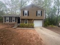 Charming two-story home with a well-manicured lawn and a welcoming front entrance at 883 Greenhedge Dr, Stone Mountain, GA 30088