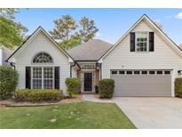 Charming one-story home with manicured lawn and attached two-car garage at 103 St Albans Way, Peachtree City, GA 30269