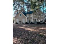 Traditional-style home with a symmetrical facade, dormer windows, and a well-maintained lawn surrounded by mature trees at 121 Tamerlane, Peachtree City, GA 30269