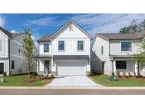 Charming two-story home with white siding, black trim, and a well-manicured front lawn at 1518 Gatekeeper Ter, Marietta, GA 30066