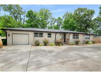 Charming one-story home with painted brick, attached garage, and well-maintained front yard landscaping at 3154 N Druid Hills Rd, Decatur, GA 30033