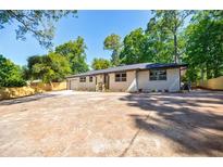 Charming single-story home with large parking pad and lush landscaping at 3154 N Druid Hills Rd, Decatur, GA 30033