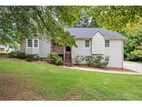 Charming home featuring a well-maintained front yard and inviting entrance staircase at 1152 Bailing Dr, Lawrenceville, GA 30043