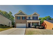 Charming brick two-story home featuring a two-car garage and a well-manicured lawn on a sunny day at 1280 Sw Vonda Ln, Mableton, GA 30126