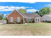 Charming brick home featuring a well-manicured front yard and lush landscaping at 1337 Highfield Dr, Lawrenceville, GA 30043