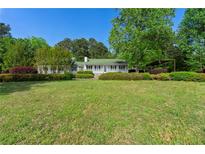 Charming single-story home with a lush front lawn and manicured landscaping creating a welcoming curb appeal at 1170 Moseley Rd, Stockbridge, GA 30281
