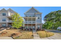 Charming two-story home with a front porch and beautifully landscaped front yard, perfect for curb appeal at 811 Corsiglia Farm, Marietta, GA 30060