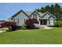 Charming home features a manicured lawn and mature landscaping at 2810 Quince Nw Ln, Acworth, GA 30101