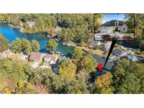 Expansive aerial view of a lakeside home surrounded by colorful fall foliage and docks, plus inset of home's front elevation at 10005 Lakeview Pkwy, Villa Rica, GA 30180