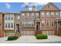 Charming townhomes with brick and stone exteriors, garages, and manicured landscaping at 346 Ardmore Ct, Atlanta, GA 30309