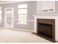 Bright living room featuring a fireplace, large window, and access to an outdoor area at 3513 Brycewood Dr, Decatur, GA 30034