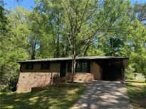 Brick home with a driveway and covered parking at 624 Moselle Sw Dr, Mableton, GA 30126